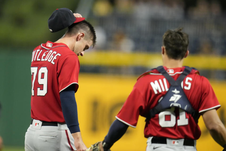 Washington Nationals starting pitcher Jackson Rutledge (79) collects himself after being hit on the head by a throw to second by catcher Drew Millas during the fourth inning of the team's baseball game against the Pittsburgh Pirates in Pittsburgh, Wednesday, Sept. 13, 2023. Rutledge faced one more hitter, giving up a two-run home run to Bryan Reynolds, then was pulled from the game - his debut in the majors. (AP Photo/Gene J. Puskar)