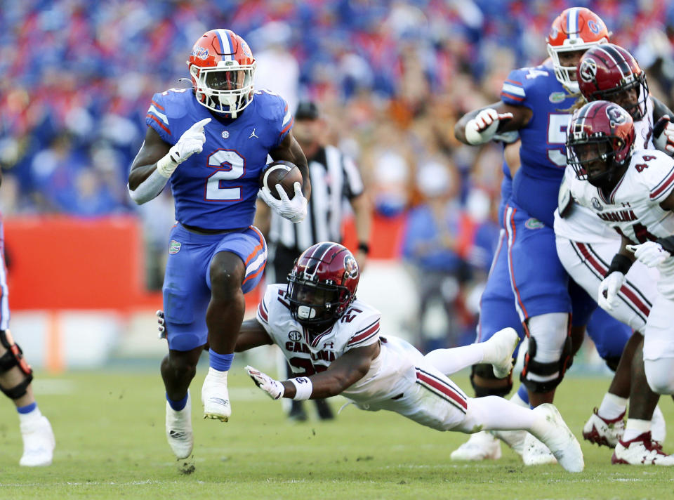 Florida running back Montrell Johnson Jr. (2) runs up the field past South Carolina defensive back Nick Emmanwori (21) during the first half of an NCAA college football game, Saturday, Nov. 12, 2022, in Gainesville, Fla. (AP Photo/Matt Stamey)