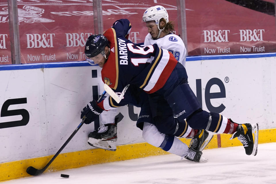 Florida Panthers center Aleksander Barkov (16) and Tampa Bay Lightning defenseman Mikhail Sergachev (98) go for the puck during the second period of an NHL hockey game, Saturday, Feb. 13, 2021, in Sunrise, Fla. (AP Photo/Lynne Sladky)