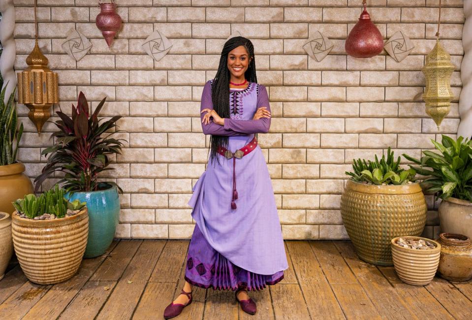 Asha from "Wish" posing for guests at Disney World at the time of the film's November theatrical release.