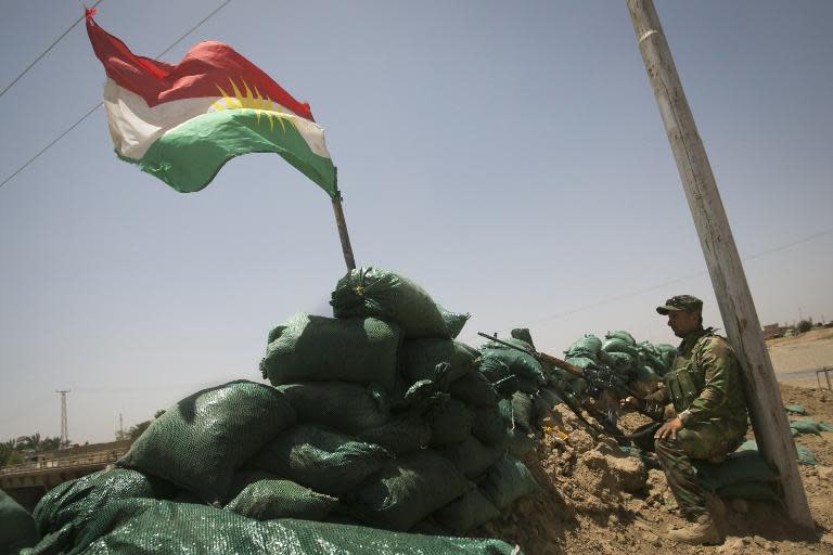 A member of Kurdish Peshmerga forces holds a position overlooking Sunni militants led by the Islamic State of Iraq and the Levant (ISIL) on June 21, 2014 in the north Iraqi village of Bashir (Basheer)