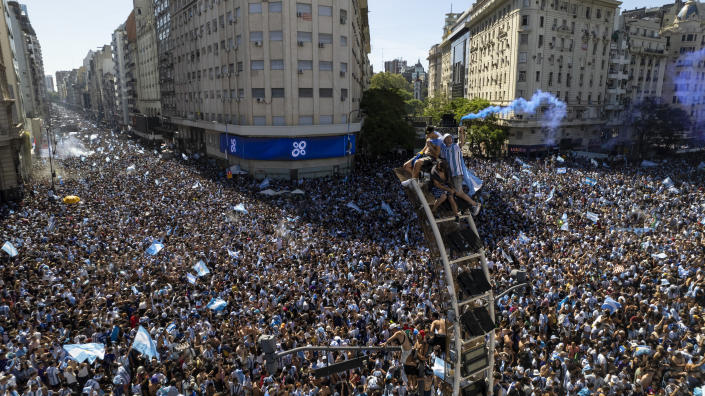 Argentine soccer fans descend on the capital's Obelisk to celebrate their team's World Cup victory over France, in Buenos Aires, Argentina, Sunday, Dec. 18, 2022. (AP Photo/Rodrigo Abd)