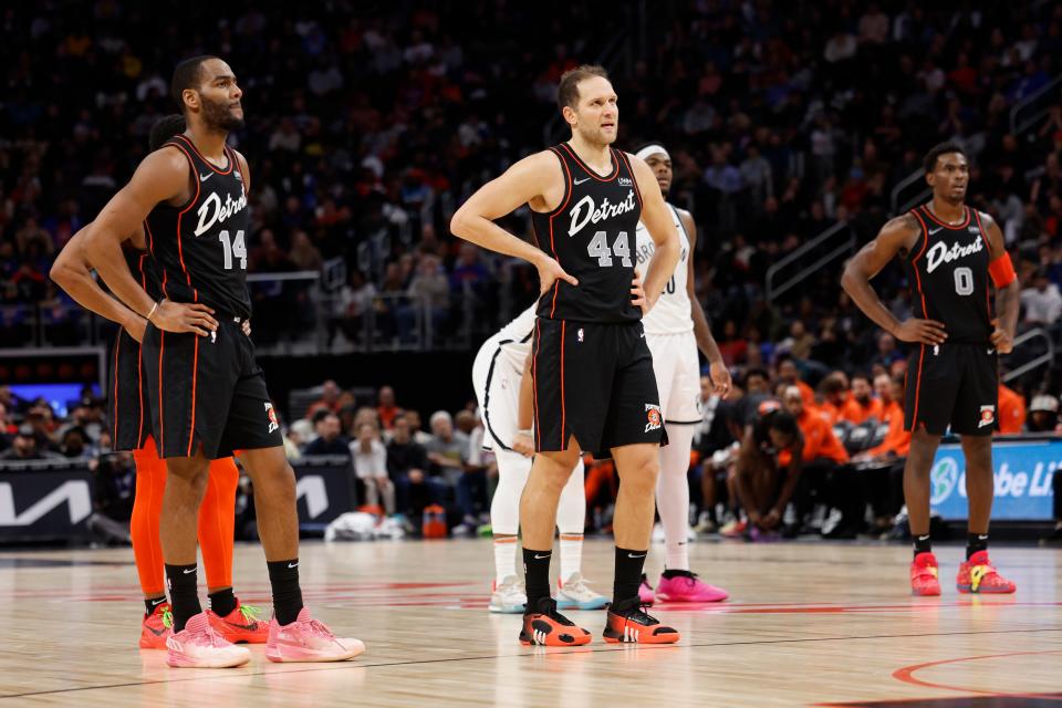 (From left) Pistons guard Alec Burks, forward Bojan Bogdanovic and center Jalen Duren look on during the second half of the Pistons' 118-112 loss to the Nets on Tuesday, Dec. 26, 2023, at Little Caesars Arena.