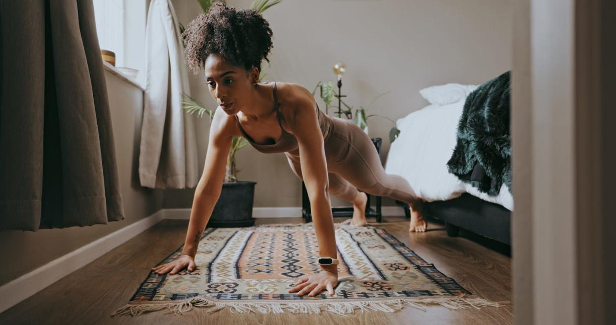 fitness, black woman and push up exercise in home for wellness, healthy lifestyle and workout young sports person, plank and female athlete on bedroom floor with strong core, body muscle and power