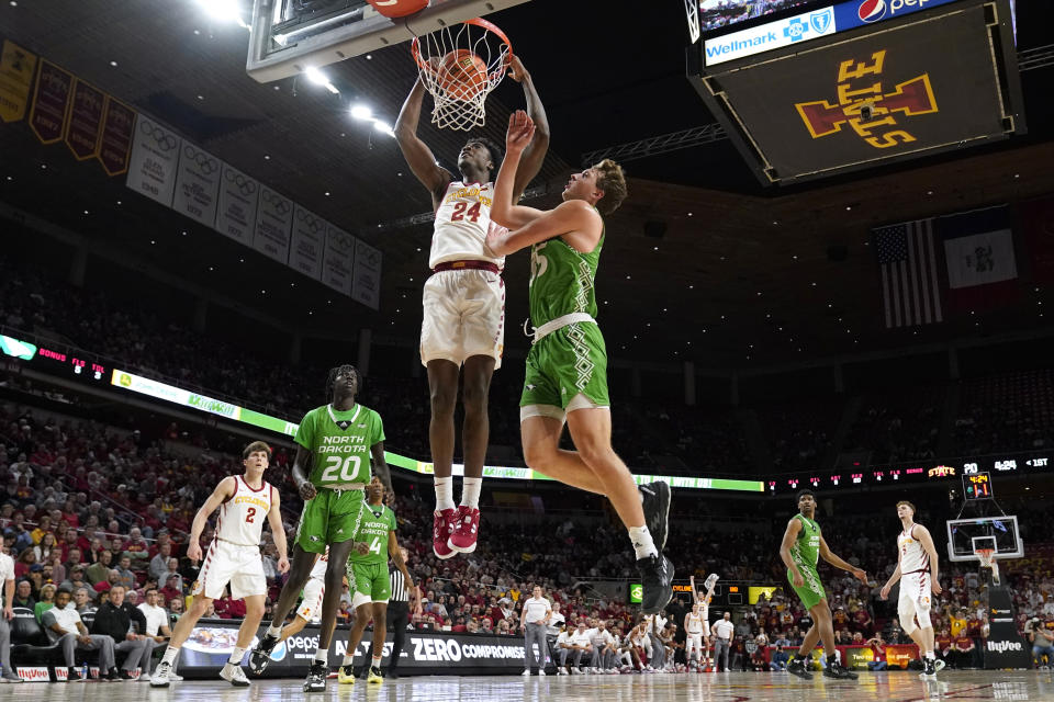 Iowa State forward Hason Ward (24) dunks the ball ahead of North Dakota forward Mitchell Sueker (35) during the first half of an NCAA college basketball game, Wednesday, Nov. 30, 2022, in Ames, Iowa. (AP Photo/Charlie Neibergall)