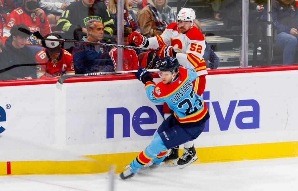 Florida Panthers center Eetu Luostarinen (27) in action against Calgary Flames defenseman MacKenzie Weegar (52) during the first period of an NHL game at FLA Live Arena on Saturday, November 19, 2022 in Sunrise, Fl.