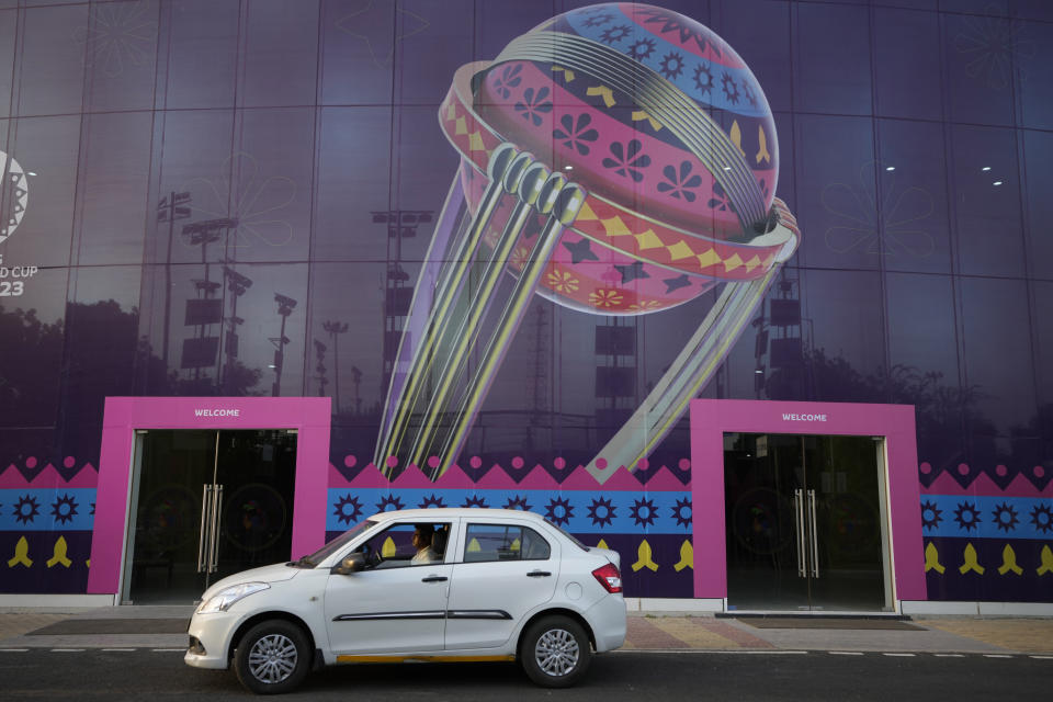 A car drives past the Narendra Modi stadium decorated ahead of the ICC cricket world cup Ahmedabad, India, Monday, Oct. 2, 2023. (AP Photo/Ajit Solanki)