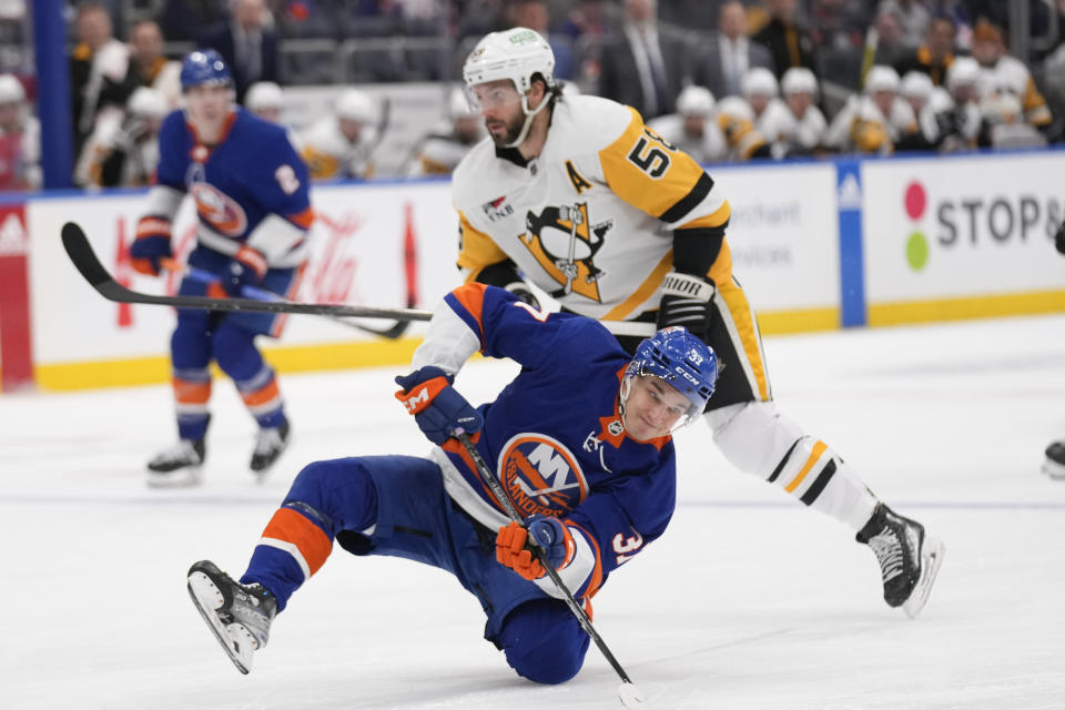 New York Islanders' Ruslan Iskhakov slips as he reaches for the puck during the second period of the team's NHL hockey game against the Pittsburgh Penguins, Wednesday, April 17, 2024, in Elmont, N.Y. (AP Photo/Seth Wenig)