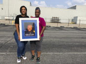 Cousins of Malik Parks, Shaunice Cherry, left, and Machelle Tompkins pose for a photo on Tuesday, July 20, 2021, in Indianapolis. Homicide rates in many American cities have continued to rise although not as precipitously as the double-digit jumps seen in 2020 and still below the violence of the mid-90s. (AP Photo/Casey Smith)