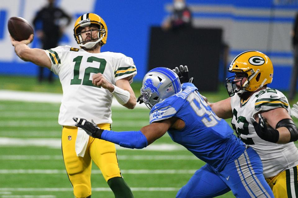 Green Bay Packers quarterback Aaron Rodgers (12) drops back to pass during the third quarter against the Detroit Lions at Ford Field.