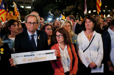FILE PHOTO: Catalan president Quim Torra (L) takes part in a protest, called by Catalan pro-independence movements ANC and Omnium Cultural, to mark one year of the imprisonment of their leaders Jordi Sanchez and Jordi Cuixart at Catalunya Square in Barcelona, Spain, October 16, 2018. REUTERS/Albert Gea/File Photo