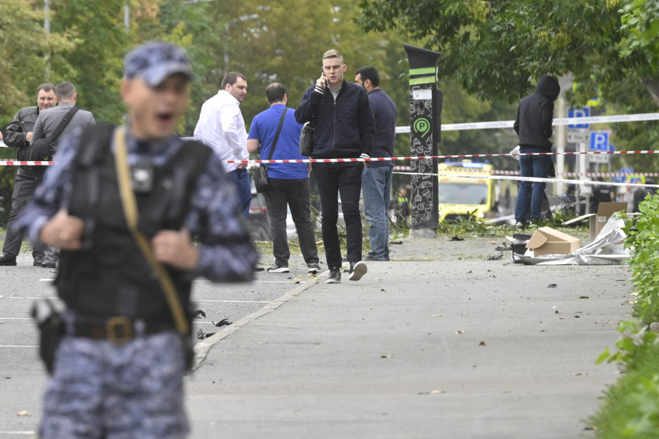 Investigators examine an area next to a damaged building after a reported drone attack in Moscow, Russia, Monday, July 24, 2023. (AP Photo)