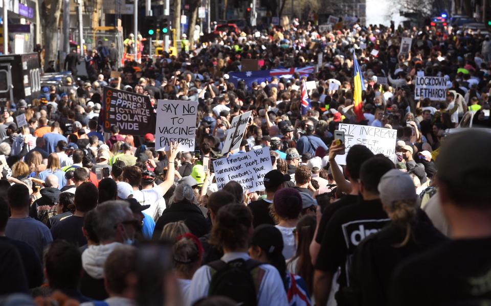 Protesters march through the streets during an anti-lockdown rally in Melbourne on August 21, 2021 as the city experiences it's sixth lockdown while it battle an outbreak of the Delta variant of coronavirus.
  / AFP / William WEST