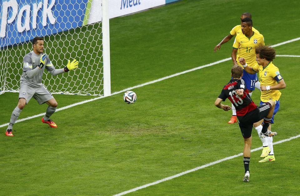 Germany's Thomas Mueller (13) scores against Brazil during their 2014 World Cup semi-finals at the Mineirao stadium in Belo Horizonte July 8, 2014. REUTERS/Leonhard Foeger