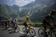 FILE - Denmark's Jonas Vingegaard, wearing the overall leader's yellow jersey, and Slovenia's Tadej Pogacar, wearing the best young rider's white jersey, climb during the eighteenth stage of the Tour de France cycling race over 143.5 kilometers (89.2 miles) with start in Lourdes and finish in Hautacam, France, Thursday, July 21, 2022. (AP Photo/Daniel Cole, File)