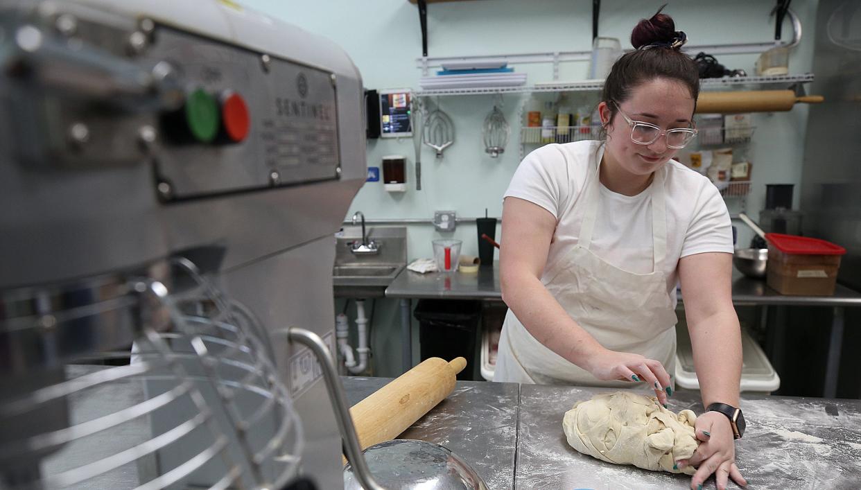 Destination Donuts social-media and catering director Elizabeth Perkins prepares dough at the new Clintonville location on opening day April 7. Destination Donuts is open from 7 a.m. to 3 p.m. Wednesdays through Sundays.