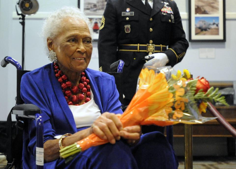 Romay Davis, 102, holds flowers after a ceremony honoring her service in World War II in Montgomery, Ala., on Tuesday. Davis is the oldest surviving member of the 6888th Central Postal Directory Battalion, which helped clear out a backlog of millions of letters and packages late in World War II in Europe.