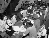 <p>In a move sponsored by the Japanese American Citizens’ League, Seattle Japanese registered for evacuation from military areas, March 10, 1942, without waiting for official action. Here a group of Japanese filled out questionnaires for women of the league. Both American-born and alien Japanese cooperated. (AP Photo/Paul Wagner) </p>