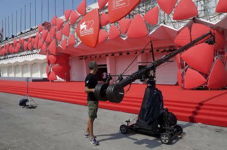 A technician checks a camera dolly in front the entrance of the venue for the 72nd Venice Film Festival in Venice August 31, 2015. REUTERS/Manuel Silvestri