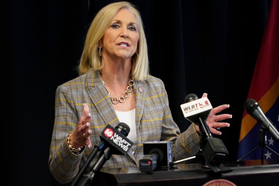 Mississippi Attorney General Lynn Fitch, right, speaks during a news conference on Tuesday, April 6, 2021 in Jackson, Miss.