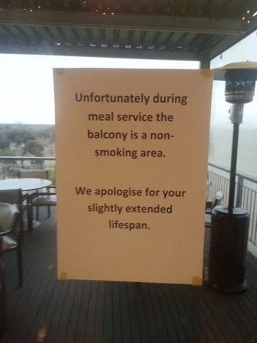 no smoking sign for the balcony that ends with, we apologize for your slightly extended lifespan