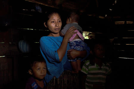 Claudia Maribel Maquin, mother of Jakelin, a 7-year-old girl who died in U.S. custody, stands with her other children inside her house in Raxruha, Guatemala December 15, 2018. REUTERS/Josue Decavele