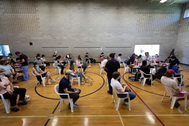 Healthcare workers with Humber River Hospital administer doses of the Moderna COVID-19 vaccine at a temporary clinic for member’s of Toronto’s Spanish-speaking community at the Glen Long Community Centre on May 14, 2021.