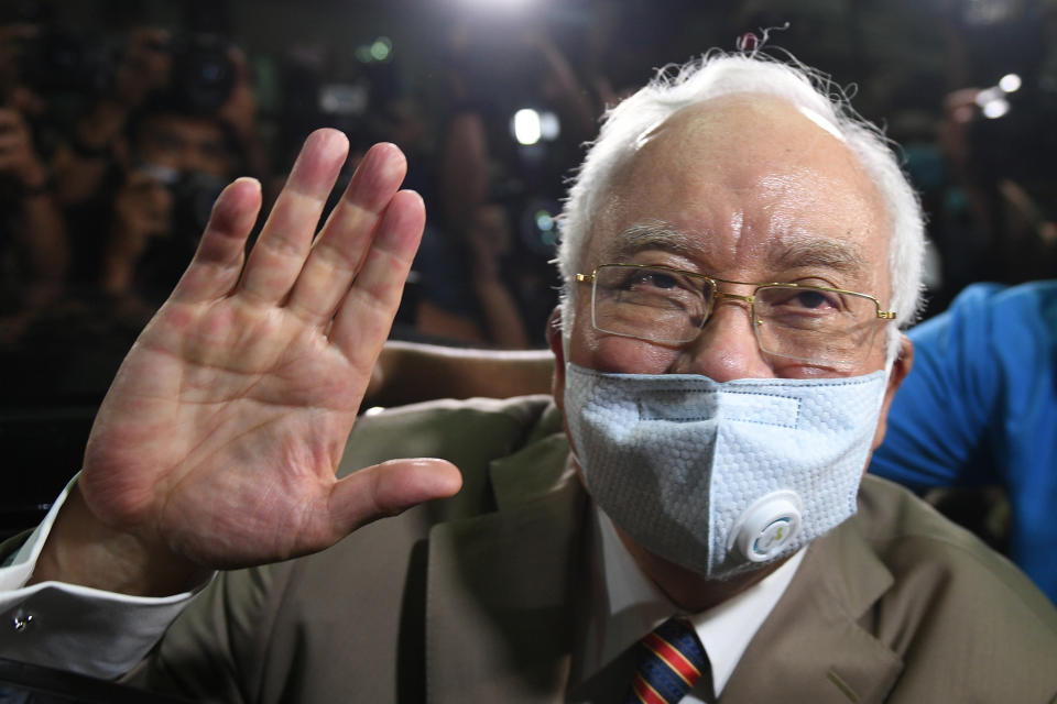 Malaysia's former prime minister Najib Razak waves as he leaves the Duta Court complex in Kuala Lumpur on July 28, 2020. He was sentenced to 12 years in jail on corruption charges linked to the multi-billion-dollar 1MDB scandal that led to the downfall of his government two years ago. (Photo: AFP via Getty Images)
