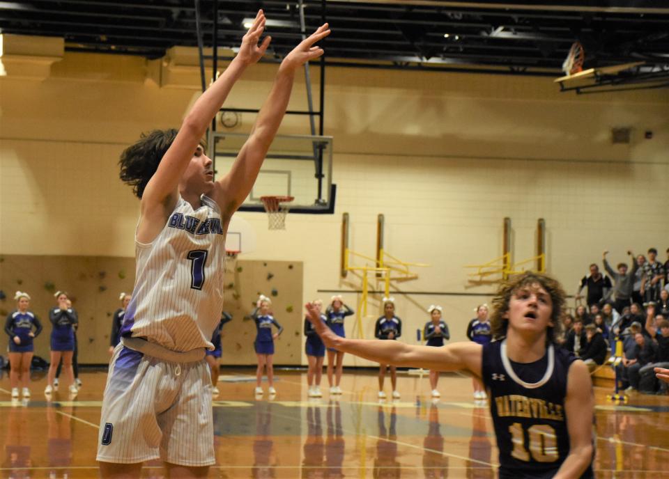 Dolgeville Mihael Blaskey (1) watches his game-winning shot against Waterville Friday. Blaskey's three-pointer gave Dolgveville a 56-55 lead - the final score - with 3.2 seconds remaining on the game clock.