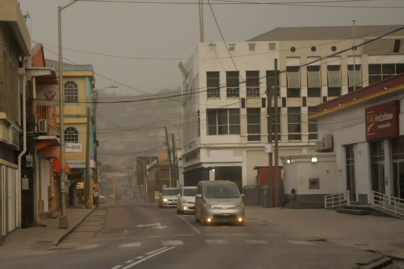 Ash covers roads a day after the La Soufriere volcano erupted after decades of inactivity in St Vincent and the Grenadines