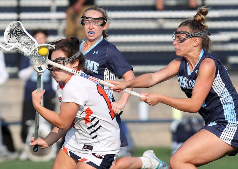 Greeley's Rowan Edson (16) gets pressure from Ursuline's Paige Moretti (13) as she tries to drive to the goal during the girls lacrosse Class A semifinal at Horace Greeley High School in Chappaqua May 23, 2023. Greeley won the game 11-8.