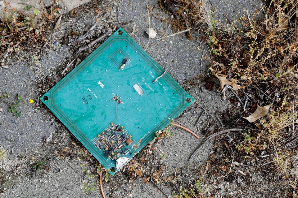 A circuit board lays on the ground in front of the US Army Communications Electronics Command building is shown overgrown Monday, June 10, 2024. Melissa Ziobro was the last historian at Fort Monmouth and worked in thie building before the Army post closed and moved to Maryland. She has written "Fort Monmouth: The U.S. Army's House of Magic."