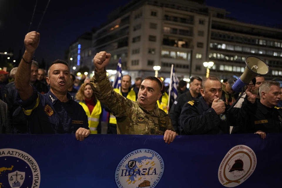 Uniformed officers shout slogans during a protest in Athens, Greece, Monday, Dec. 18, 2023. About 1,500 people took part in the rally, organized by police, firefighters and coast guard unions in response to the non-legalization of their profession as hazardous. (AP Photo/Thanassis Stavrakis)