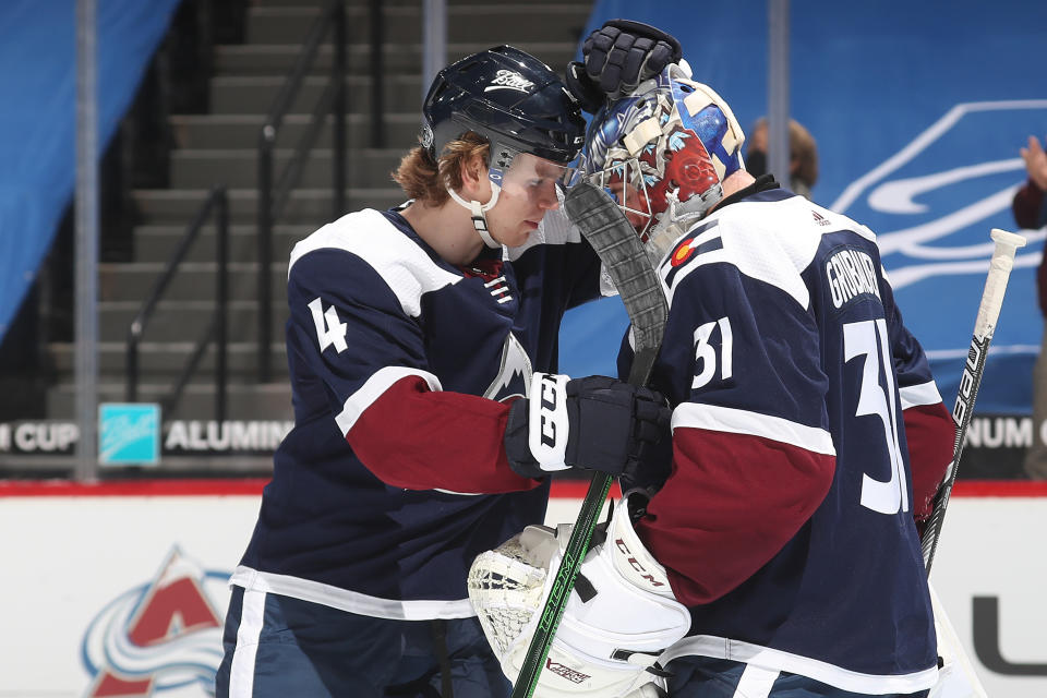 DENVER, COLORADO - FEBRUARY 02: Goaltender Philipp Grubauer #31of the Colorado Avalanche celebrates a win against the Minnesota Wild with teammate Bowen Byram #4 at Ball Arena on February 02, 2021 in Denver, Colorado. The Avalanche defeated the Wild 2-1. (Photo by Michael Martin/NHLI via Getty Images)