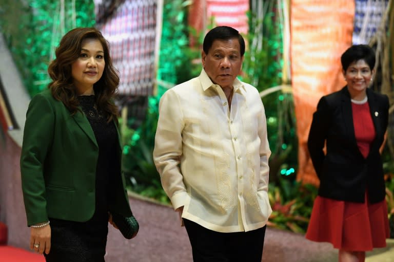 Philippine President Rodrigo Duterte (C) and his partner Honeylet Avancena (L) arrive to meet leaders upon their arrival for the opening ceremony of the Association of Southeast Asian Nations (ASEAN) leaders' summit in Manila