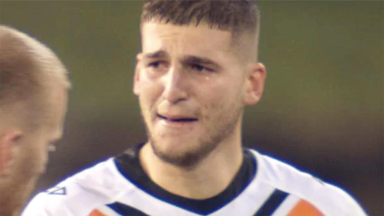 Adam Doueihi, pictured here in tears on the field after the Wests Tigers' loss.