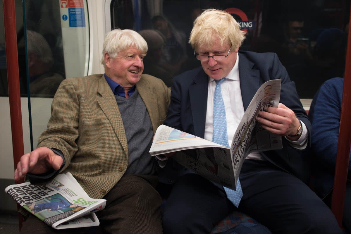 Boris Johnson sits next to his father Stanley (left) on the Bakerloo Line (PA Archive)