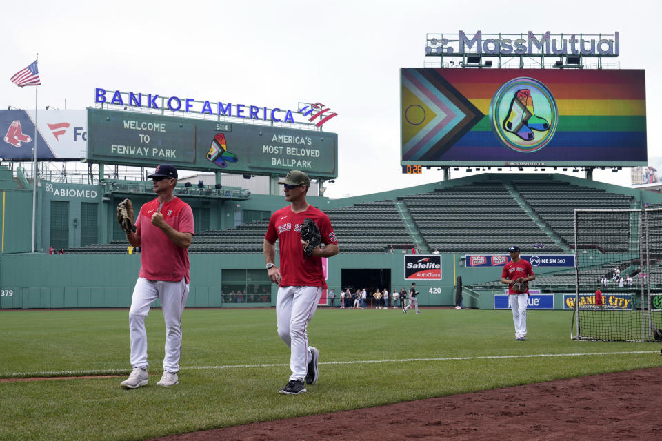 A rainbow adorned Boston Red Sox logo is displayed on the center field video board on Pride Night prior to a baseball game at Fenway Park, Tuesday, June 13, 2023, in Boston. Almost 80 years after Jackie Robinson broke the majors’ color barrier in a landmark moment for the American civil rights movement, the dueling expressions of LGBTQ+ support and seeming rejection recalled the question of when the big leagues might welcome their first active openly gay player. (AP Photo/Charles Krupa)