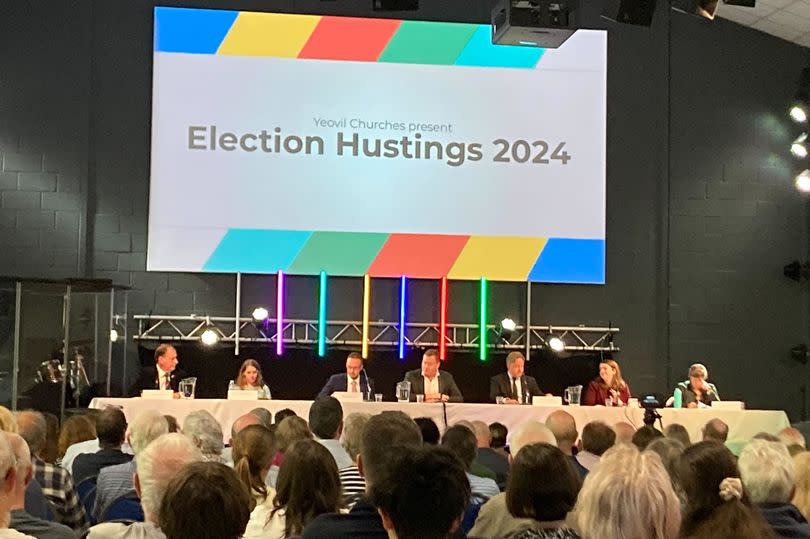 The Gateway hustings in Yeovil. From left, Steve Ashton (independent), Laura Bailhache (Reform UK), Adam Dance (Liberal Democrat), moderator Simon Collins, Marcus Fysh (Conservative), Rebecca Montacute (Labour), Serena Wootton (Green)