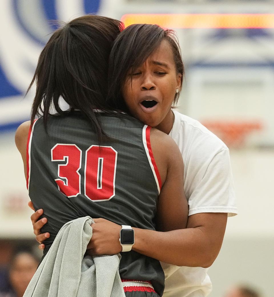 Fishers Tigers Olivia Smith (31) runs across the court to hug her sister Fishers Tigers Hailey Smith (30) after defeating the Hamilton Southeastern Royals on Saturday, Dec. 17, 2022 at Hamilton Southeastern Royals in Fishers. The Fishers Tigers defeated Hamilton Southeastern Royals, 49-48. 