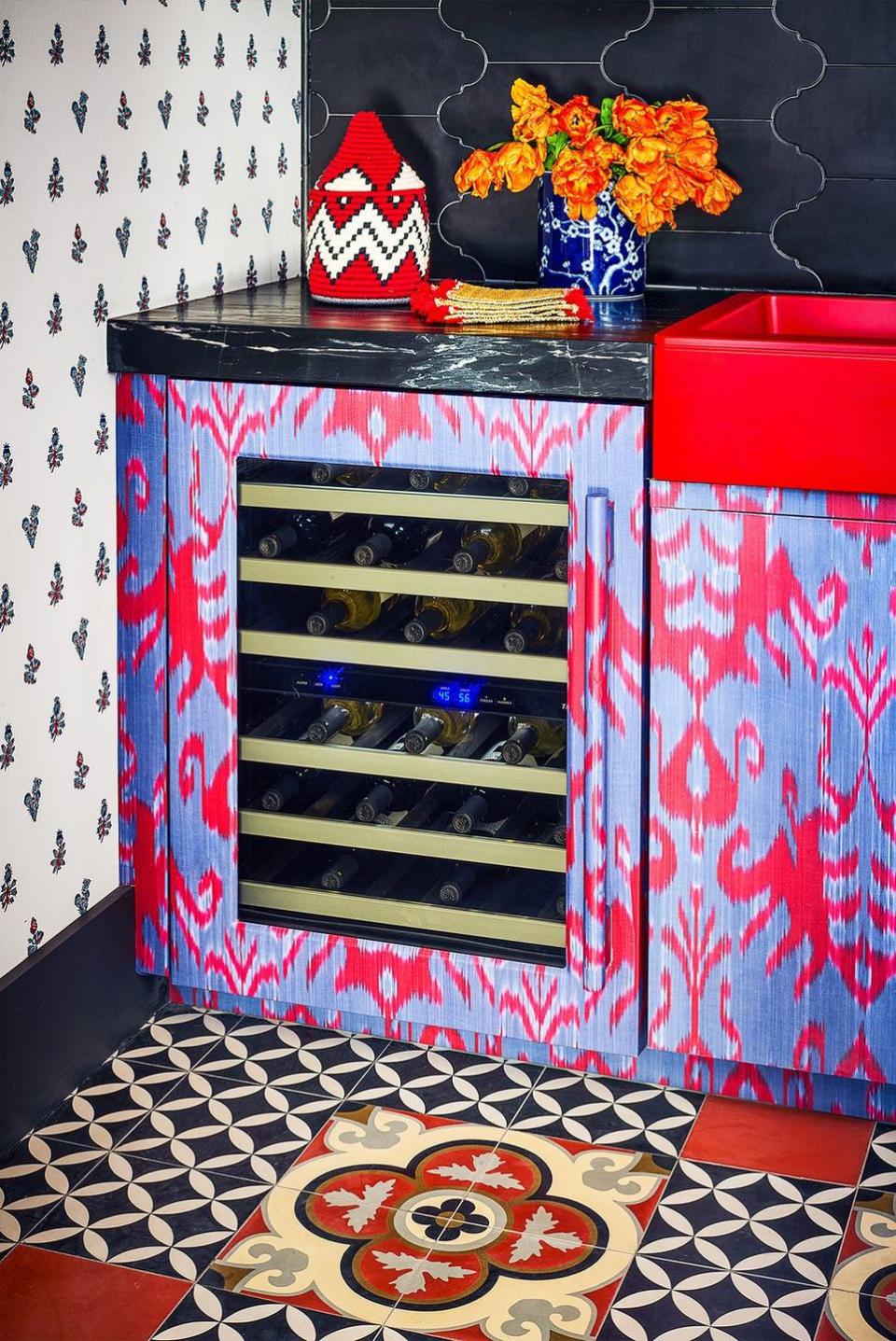 <p>Match your mini wine fridge to your cabinets. Michelle Nussbaumer chose her own purple and red ikat print for a romantic pop.</p>