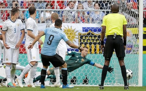 Uruguay's Luis Suarez scores his side's first goal during the group A match between Uruguay and Russia at the 2018 soccer World Cup at the Samara Arena in Samara, Russia, Monday, June 25, 2018 - Credit: AP