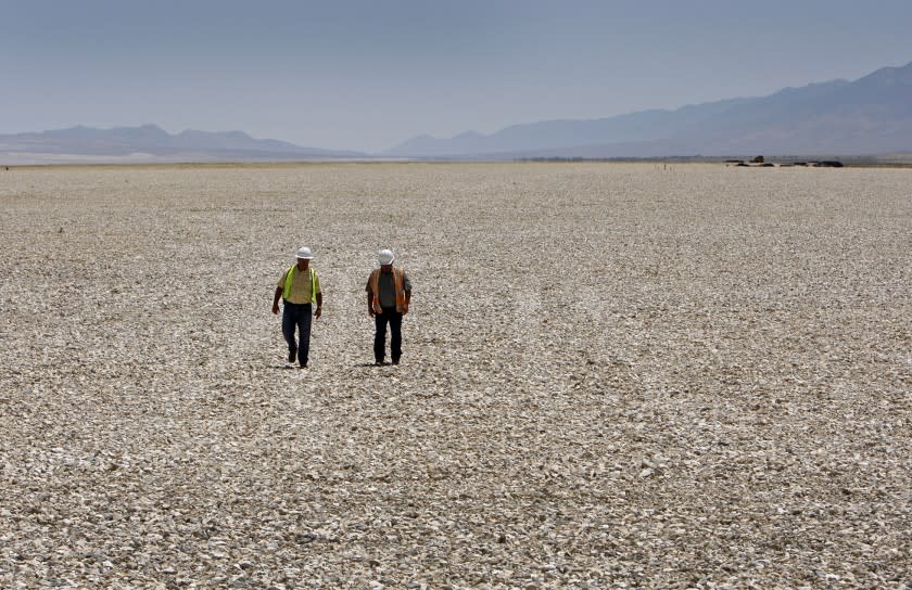 People walk on the gravel project in Owens Lake at the Southern end of the Owens Valley.