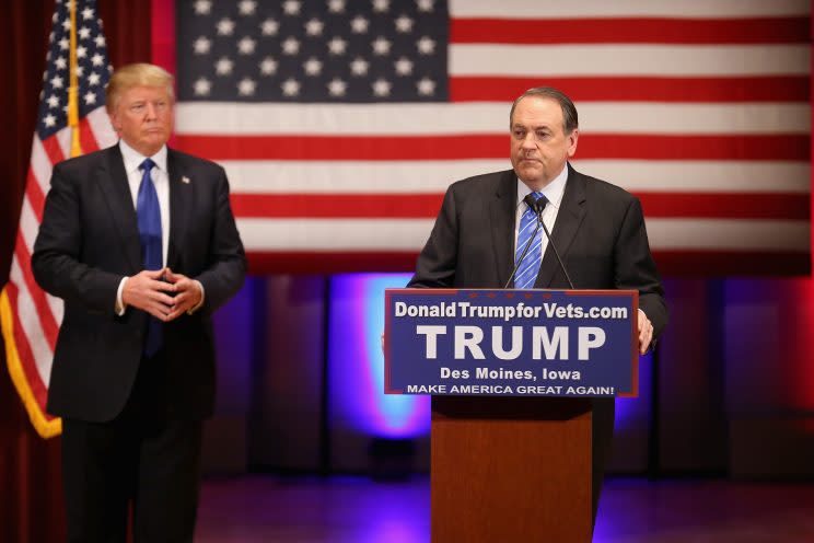 Republican presidential candidate Donald Trump listens as then-fellow candidate Mike Huckabee speaks to veterans at Drake University in Des Moines, Iowa on January 28, 2016.(Photo: Christopher Furlong/Getty Images)