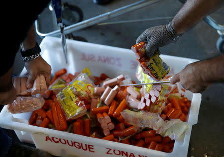 Members of the Public Health Surveillance Agency collect sausages to analyse in their laboratory, at a supermarket in Rio de Janeiro, Brazil, March 20, 2017. REUTERS/Ricardo Moraes