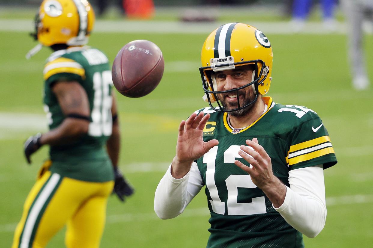 Aaron Rodgers of the Green Bay Packers warms up before the NFC Divisional Playoff game against the Los Angeles Rams at Lambeau Field on January 16, 2021 in Green Bay, Wisconsin.