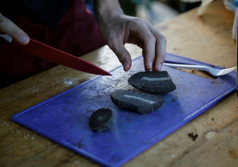 A participant at the 15th annual 'World Testicle Cooking Championship' prepares a dish in the village of Lipovica, Serbia on September 1, 2018