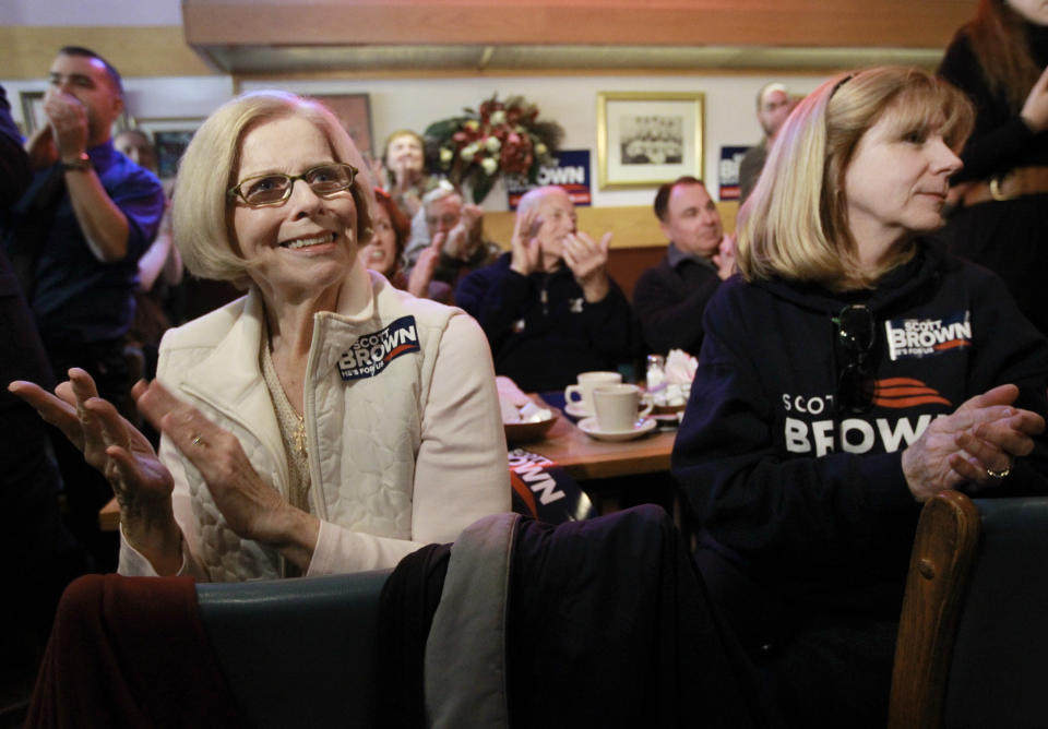 Marion Mairs, of Milford, Mass., left, a supporter of U.S. Sen. Scott Brown, R-Mass., not shown, applauds along with others during a Brown campaign event at a restaurant, in Milford, Mass., Thursday, Nov. 1, 2012. Brown and Democratic challenger Elizabeth Warren have already spent nearly $68 million pursuing the same U.S. Senate seat, shattering all previous spending records in Massachusetts. (AP Photo/Steven Senne)