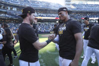 San Diego Padres' Juan Soto, right, celebrates with Jake Cronenworth following a baseball game against the Chicago White Sox after clinching a wild-card playoff spot, Sunday, Oct. 2, 2022, in San Diego. (AP Photo/Derrick Tuskan)