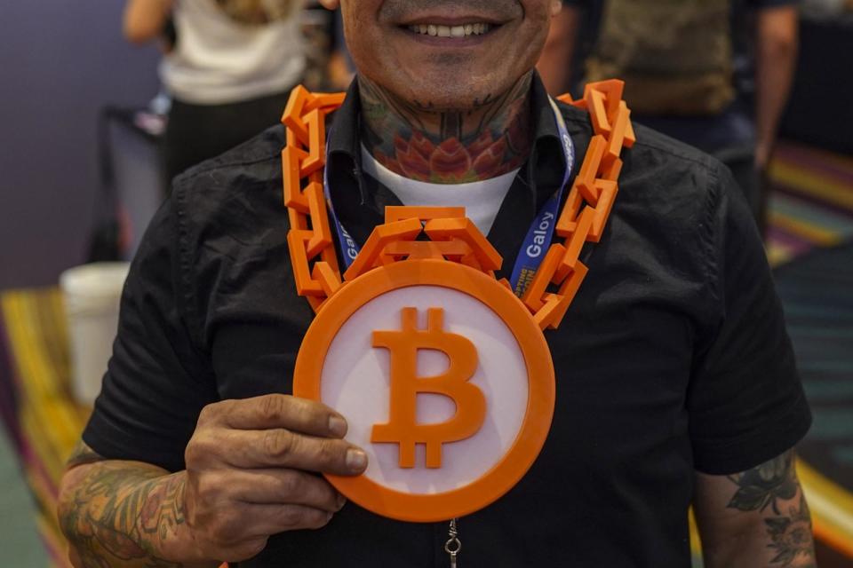 PHOTO: An attendee wearing a Bitcoin necklace during the Adopting Bitcoin 2023 Summit in San Salvador, El Salvador, Nov. 7, 2023.  (Camilo Freedman/Bloomberg via Getty Images)